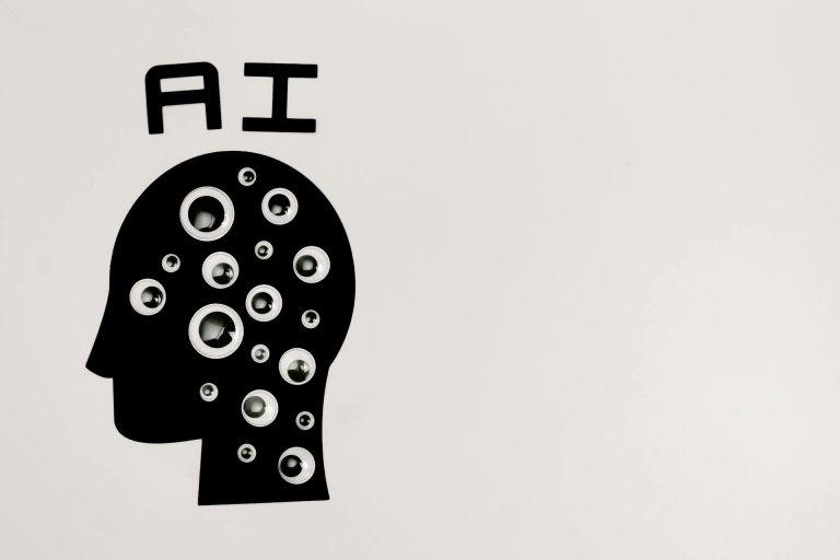 AI 101 guide, what is AI, a human head silhouette with eye-like circles underneath the word “AI”