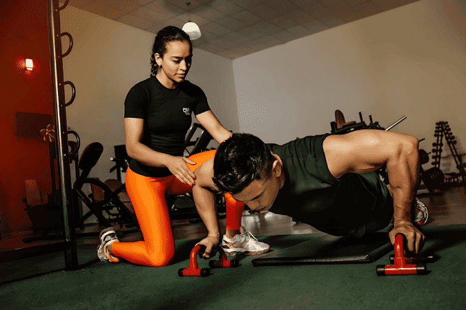 trainer assisting a man with push-ups, highlighting AI advantage and artificial intelligence in fitness training